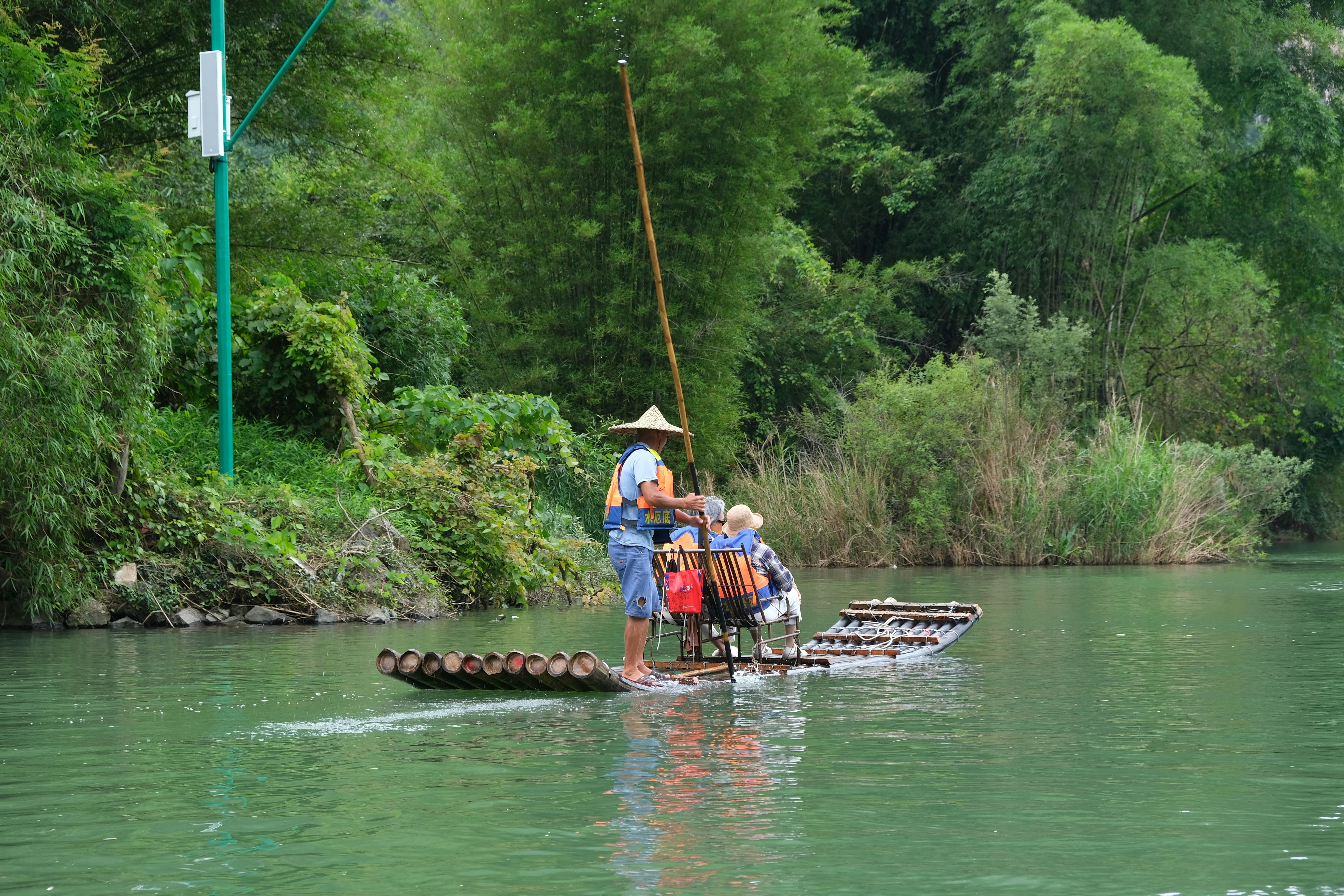 People on a bamboo raft on a tropical river